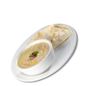 Bowl of hummus finished with olive oil, served with pita