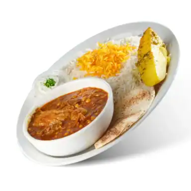 Beef and eggplant stew in a bowl beside rice, a potato wedge and pita